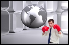 Businessman wearing red boxing gloves standing beneath a globe, symbolizing the challenges of prisoner reentry, overcoming a felony conviction, resilience, determination, and fighting to rebuild a successful life.